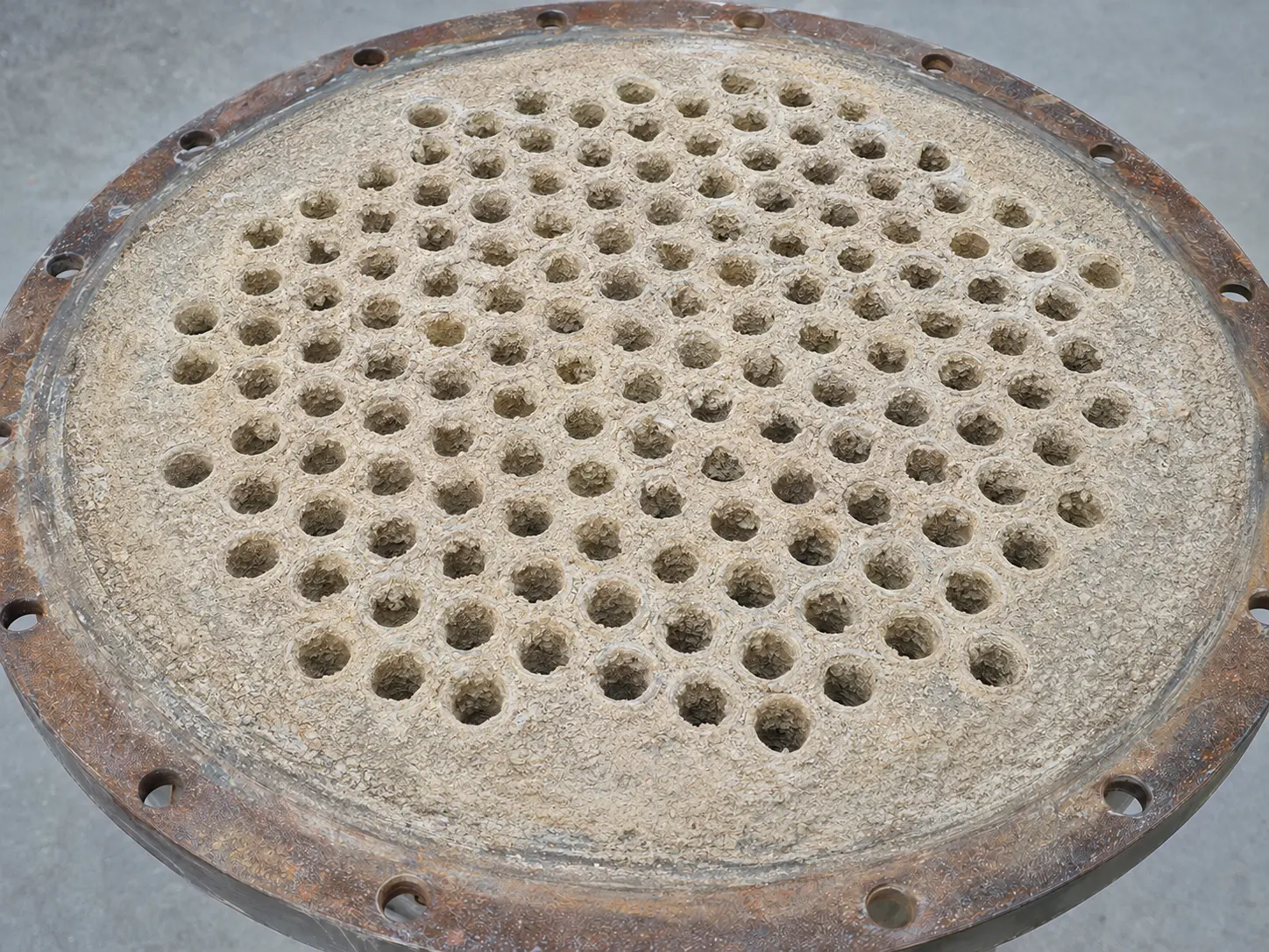 Tube sheet with severe deposits before treatment